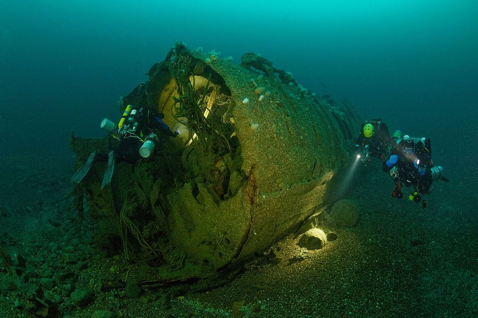 Underwater cameraman Richard Stevenson and a colleague explore the wrecks of U-boats lying off the north-west coast of Ireland. Photo: BBC NI/Alleycats TV